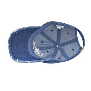 Detail view of 100% cotton washed denim cap interior with adjustable buckle
