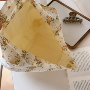 Detail view of cotton floral hobo bag interior with magnetic clasp and fabric lining
