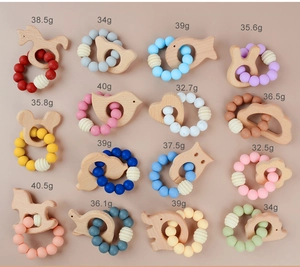 Flat lay of diverse wooden animal teethers with colorful silicone beads and weight labels