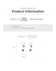 Detail view of gold earrings with green faceted gems, copper and rhinestone materials