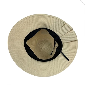 Detail view of woven straw hat interior featuring black sweatband and adjustable drawstring