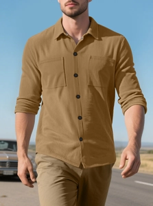 Outdoor shot of men's corduroy shirt jacket in khaki with cargo pockets and button closure