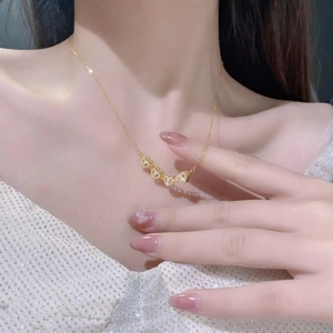 Elegant gold clover heart necklace with small zircons on female neck for a chic look