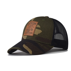 Detail of camouflage trucker hat with mesh back and embossed deer leather patch
