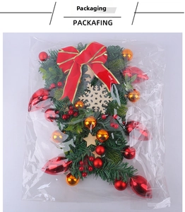 Close-up of Christmas wreath set with red bows, festive baubles, and wooden snowflakes