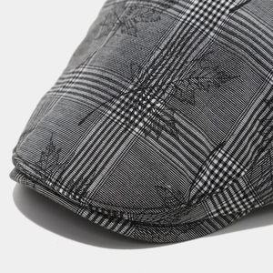Macro shot of the black and white plaid cotton fabric and fine stitching on the peak cap