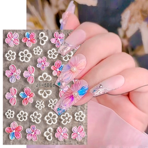 Macro detail of 5D embossed nail stickers featuring pink flowers and delicate bows