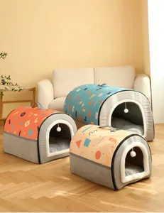 Detail showing plush geometric cat house with top handle and hanging toy ball accessory