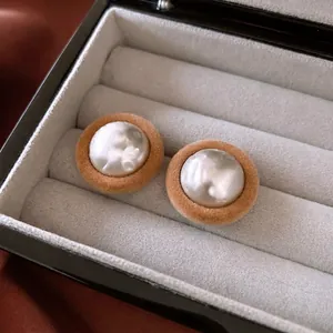 Elegant plush round stud earrings with baroque pearls in a premium jewelry box gift display