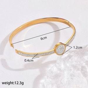 Detailed view of gold stainless steel bangle with dimensions 6cm and rhinestone decor