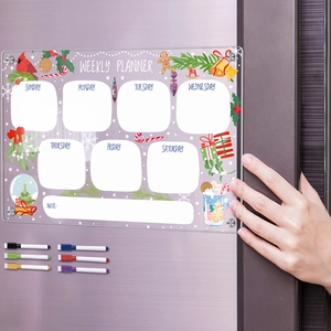 Detail of magnetic acrylic weekly planner on fridge with markers and Christmas theme