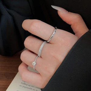 Close-up of three silver-tone rings with zircons on model hand for a minimalist look