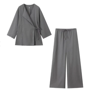 Detailed flat lay of gray two-piece lounge set with side-tie wrap top and drawstring pants