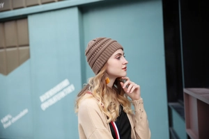 Outdoor close-up of a brown chunky knit beanie with a textured warm weave for women