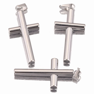 Macro view of three silver cylindrical cross pendants with polished metallic finish