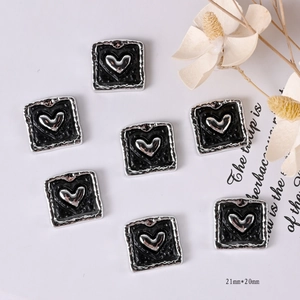 Macro view of vintage heart-shaped black and silver buttons sized 21mm by 20mm