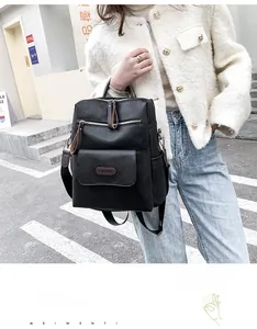 Close-up of the black pebbled faux leather backpack with silver zippers and magnetic flap pocket