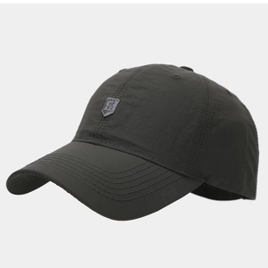 Close-up of lightweight quick-dry golf hat fabric with a stitched shield logo detail