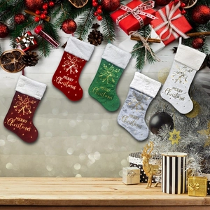 Set of 5 festive Christmas stockings with reindeer patterns on holiday background