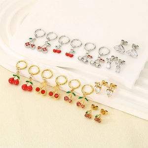 Detail view of cute cherry and strawberry fruit earrings set with crystal rhinestones