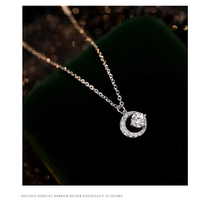 Macro detail of S999 silver crescent moon necklace with sparkling moissanite stone
