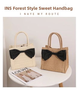 Detail of straw tote bags featuring large black bows and natural woven texture