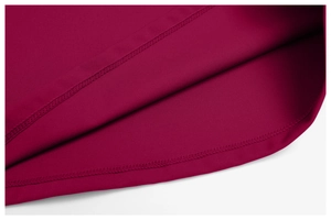 Detail of flat double-stitched hem on burgundy yoga shirt with high-quality knit texture