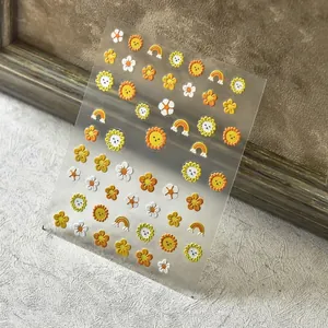 3D embossed sunflower nail stickers with vibrant yellow daisy and rainbow patterns