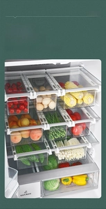 Hanging refrigerator drawer organizer showing clear bins with fresh vegetables and eggs