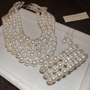 Detail of multi-layer pearl jewelry set with sparkling crystal clasp on a display tray