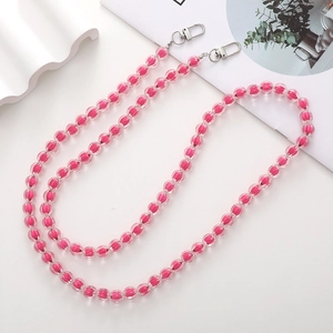 Pink acrylic bead phone crossbody chain with metal clasps on minimalist magazine backdrop