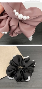 Détail de chouchou en satin orné de perles élégantes en noir et couleur pâte de haricot