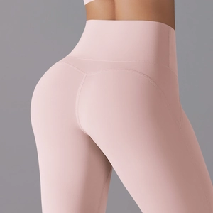 Close-up of pink high-waisted yoga leggings showing heart-shaped back stitching and seams