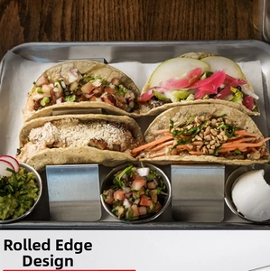 Detail view of stainless steel taco holders with rolled edges on a metal grilling tray