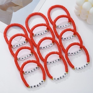 Set of 12 red polymer clay beaded bracelets with gold accents and white CHEER letter beads