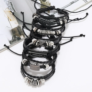 Detail view of 6-piece punk black leather bracelet set featuring feather and cross charms