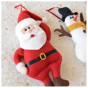 Detail of red and white felt Santa and snowman ornaments with golden buckle accents