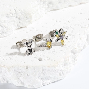 Detail of 925 sterling silver animal and crown stud earrings with colorful cubic zirconia