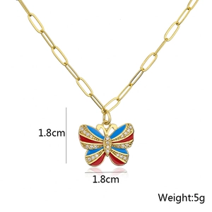 Detail view of 1.8cm butterfly pendant with enamel finish and zircon settings on a gold chain