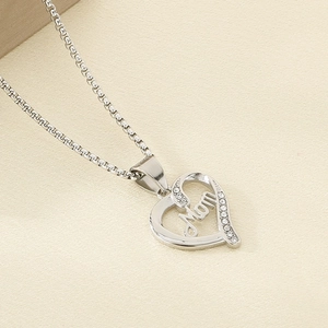 Macro view of silver heart pendant with Mom lettering and sparkling rhinestones