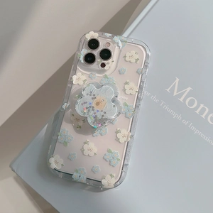 Floral iPhone case with liquid glitter flower stand on a book, showing transparent TPU detail