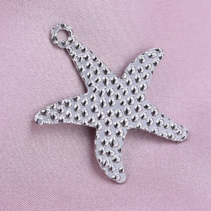 Detailed close-up of textured 304 stainless steel starfish pendant with hammered surface