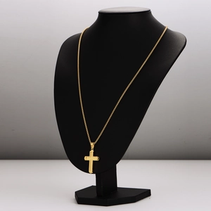Gold stainless steel cross pendant necklace on a black mannequin display stand