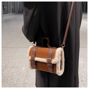 Brown faux suede cylindrical handbag with white faux fur trim and leather shoulder strap