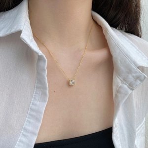 Close-up of S925 silver necklace with sparkling square-cut zircon pendant on model