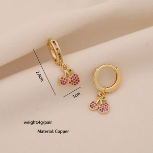 Detailed view of cherry pendant earrings with pink and green zircons on copper base