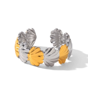 Macro side view of dual-tone gold and silver scalloped adjustable stainless steel ring