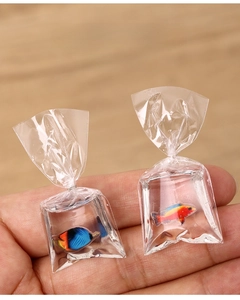 Gros plan d'un porte-clés miniature en forme de sachet d'eau avec un poisson réaliste