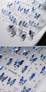 Macro detail of blue aurora butterfly nail stickers with metallic laser effect on tips