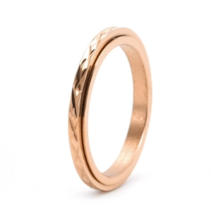 Close-up of rose gold spinning ring with geometric diamond-cut patterns and facets